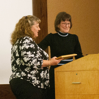 Kristen Green, MD, accepts the Rural Health Hero Award from nominator, Diane Potts.